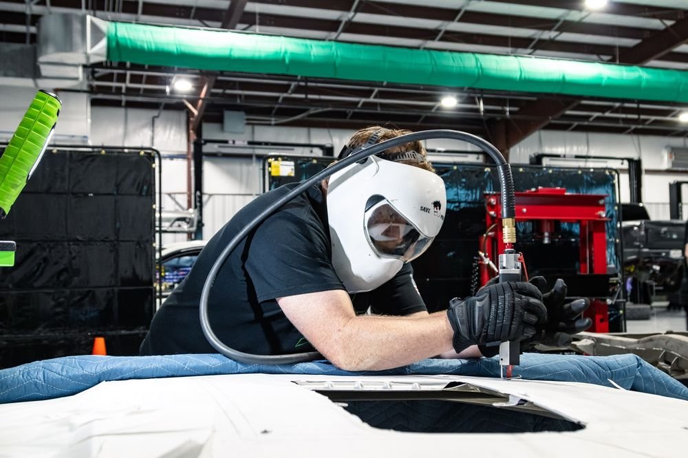 Technician cutting a custom clearance panel
