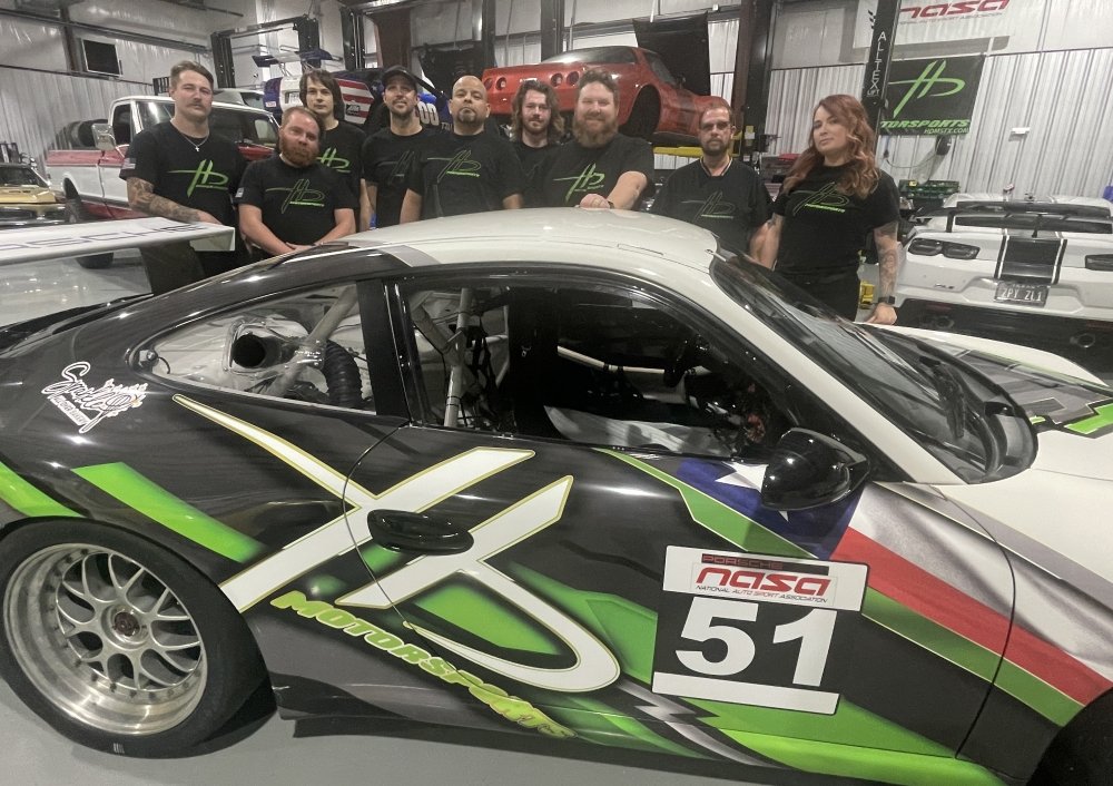 The HD Motorsports team with their NASA-liveried Porsche race car